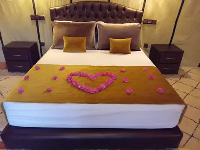 a bed with a heart made out of flowers on it at Amandesertcamp in Lac Yasmins
