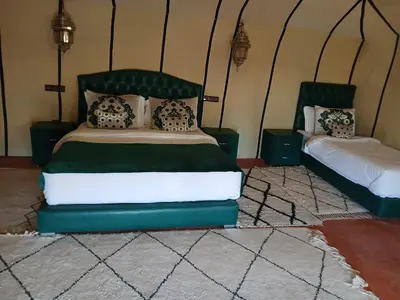 a bedroom with a bed and two pillows at Amandesertcamp in Lac Yasmins