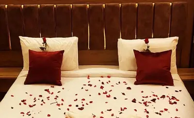 a bed with red hearts on it with two pillows at Zeus Sahara Luxury Camp in Merzouga