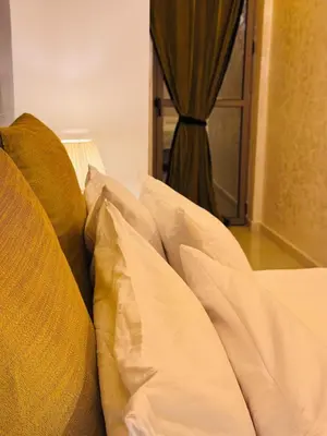 a couch with white sheets and a window in a room at URBAN WHITE Elya 2 in Beni Mellal