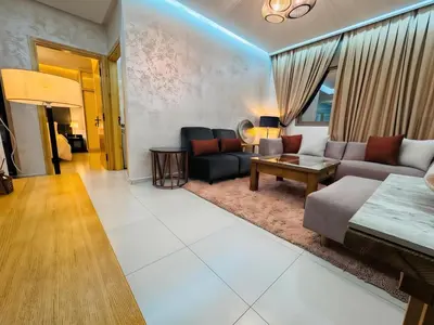 a living room with a couch and a table at URBAN WHITE Elya 2 in Beni Mellal