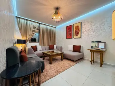 a living room with a couch and a table at URBAN WHITE Elya 2 in Beni Mellal