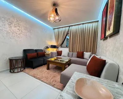 a living room with a couch and a table at URBAN WHITE Elya 2 in Beni Mellal