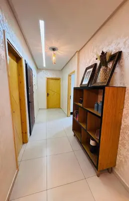 a hallway of a house with a wooden cabinet at URBAN WHITE Elya 2 in Beni Mellal