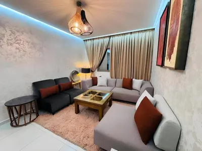 a living room with a couch and a table at URBAN WHITE Elya 2 in Beni Mellal
