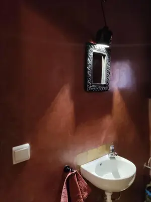 a bathroom with a sink and a mirror on the wall at Tigmi N'Dounit Lodge et Nature in Boumalne