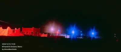 a city at night with red and blue lights at Daraa Valley House in Mhamid