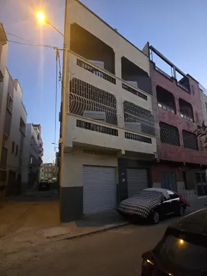 a building with a car parked in front of it at Appartement 3S in Meknès