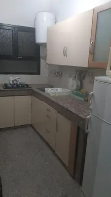 a kitchen with a sink and a white refrigerator at Appartement 3S in Meknès