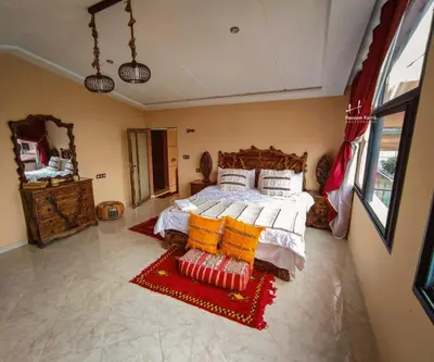 a bedroom with a large bed in a room at Tynass Ferme - Atlas Room Fes