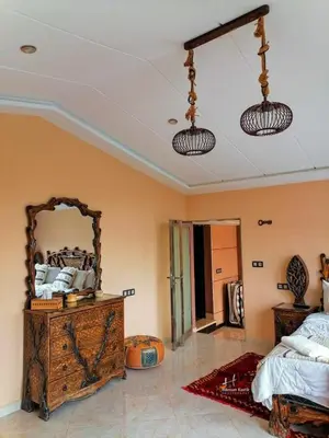 a bedroom with a large mirror and a bed at Tynass Ferme - Atlas Room Fes
