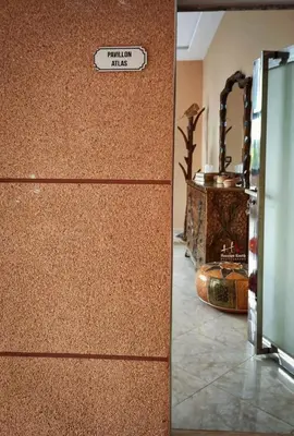 a cork wall with a sign that reads want to hug at Tynass Ferme - Atlas Room Fes
