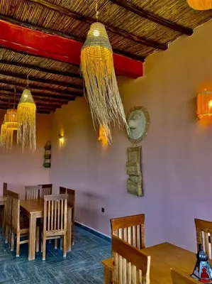 a dining room with a table and chairs at Ferme Tynass - Paris Room With Balcony Fes