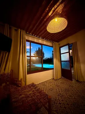 a bedroom with a bed and a large window at Tynass Ferme - Walili Room Fez