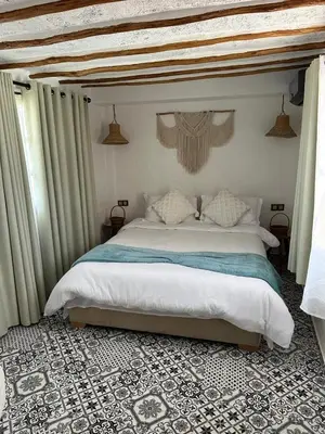 a bedroom with a large bed with a canopy at Ferme Tynass - Tynass Suite - Spacious Suite in Tynass Farm