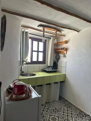 a small kitchen with a sink and a mirror at Ferme Tynass - Tynass Suite - Spacious Suite in Tynass Farm