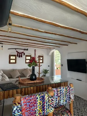 a living room with a table and two chairs at Ferme Tynass - Tynass Suite - Spacious Suite in Tynass Farm