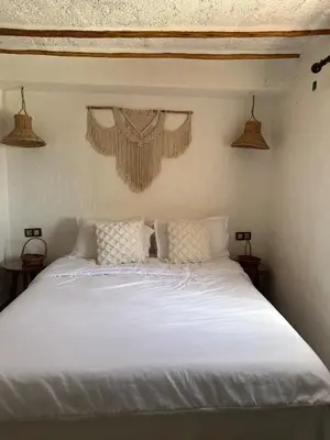 a bedroom with a white bed with two pillows at Ferme Tynass - Tynass Suite - Spacious Suite in Tynass Farm