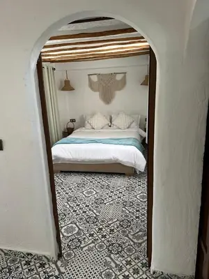 a bedroom with a bed and an archway with a bed sidx sidx at Ferme Tynass - Tynass Suite - Spacious Suite in Tynass Farm