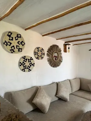 a living room with a couch and plates on the wall at Ferme Tynass - Tynass Suite - Spacious Suite in Tynass Farm