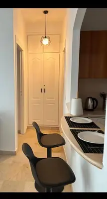 a kitchen with a counter and a black chair at Mandela in Oulad Akkou