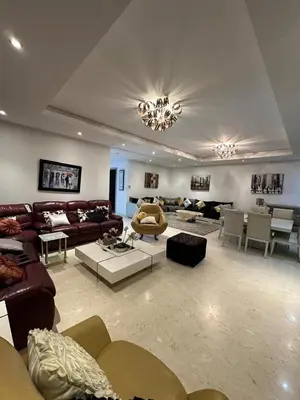 a large living room with couches and tables and chairs at Spacious and comfortable villa for holidays in Oulad Akkou
