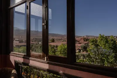 a window with a view of the countryside seen through it at Atlas Aura Hotel Ourika - Marrakech