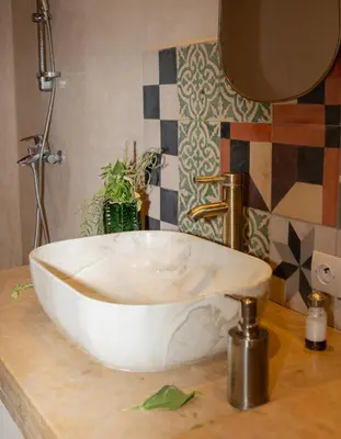 a white bowl sink on a counter in a bathroom at Atlas Aura Hotel Ourika - Marrakech