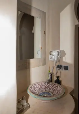 a sink in a bathroom with a mirror at Atlas Aura Hotel Ourika - Marrakech