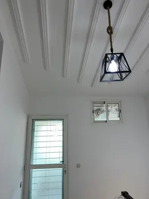 a white room with a window and a chandelier at Chalet cosy familial à Imouzzer - calme, nature et confort in Imouzzer Kandar
