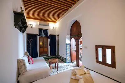 a living room with a couch and a table at Dar Rass Jnane in Fès