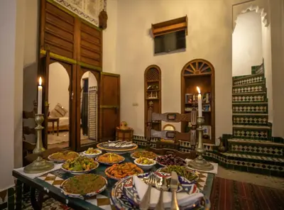 a table with many plates of food on it at Dar Rass Jnane in Fès