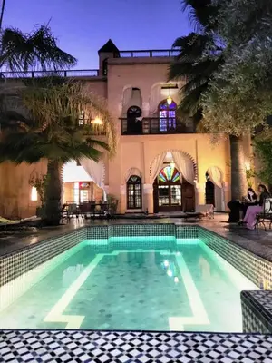 a swimming pool in front of a house at Chambre SAPHIR - Riad Lotus Bleu in Fès