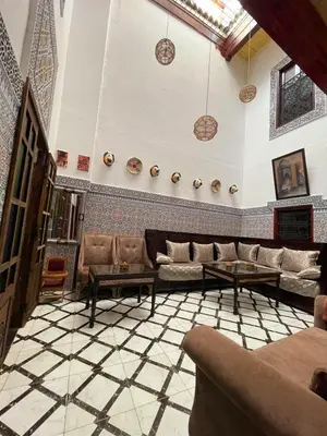 a large living room with couches and a tiled floor at Dar Bab Boujloud Fez in Fès