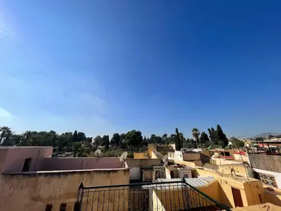 a group of buildings with a blue sky in the background at Dar Bab Boujloud Fez in Fès