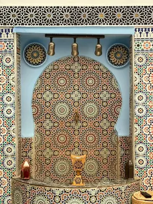 a room with a table with a patterned wall at Dar Bab Boujloud Fez in Fès