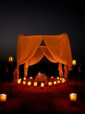 a tent with candles and lights in the dark at Golden dunes luxury camp in Merzouga