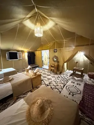a room with two beds in a tent at Golden dunes luxury camp in Merzouga