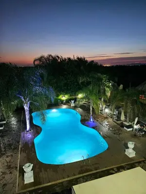 an overhead view of a swimming pool at night at Eden villa Marrakech in Douar bel Rhanodour