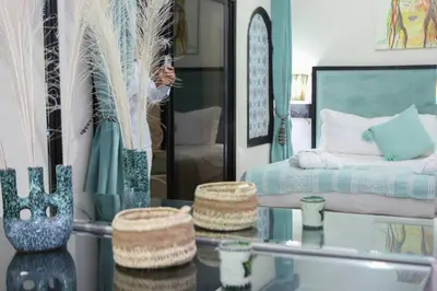 a bedroom with a bed and a glass table with a glass table sidx sidx sidx at Eden villa Marrakech in Douar bel Rhanodour
