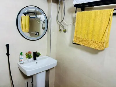 a bathroom with a sink and a mirror at Appartement style traditionnel climatisé chaufé in Fès