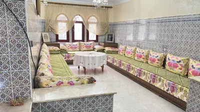 a living room with couches and a table in a room at Appartement style traditionnel climatisé chaufé in Fès