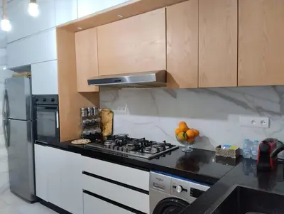 a kitchen with a stove and a refrigerator at Appartement style traditionnel climatisé chaufé in Fès