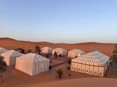 a group of buildings in the desert at Oasis Merzouga Retreat in Merzouga