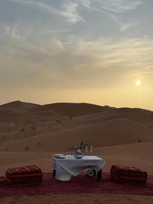 a table in the middle of the desert at Oasis Merzouga Retreat in Merzouga