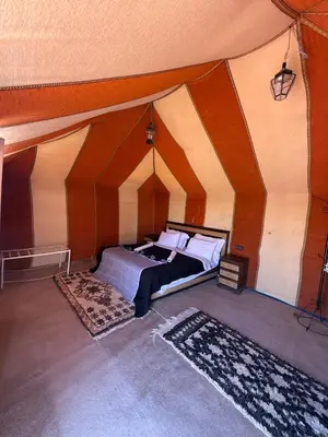 a bedroom with a bed in a room at Oasis Merzouga Retreat in Merzouga