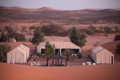 a building in the middle of a desert at Oasis Merzouga Retreat in Merzouga