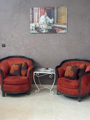 two red chairs and a table in a living room at Oasis de Calme Villa Piscine Hammam & Vues Atlas in Ouled el guerne