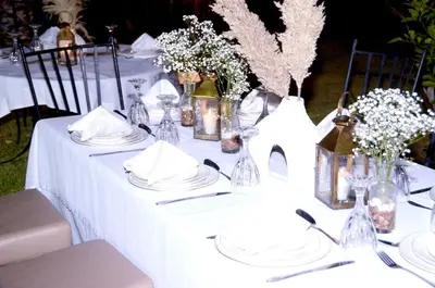 a white table with plates and vases on it at Villa Eden Marrakech - Luxury Spa Events in Douar bel Rhanodour