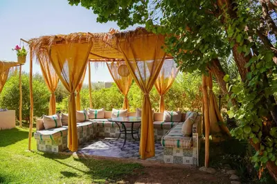 a gazebo with a couch and a table at Villa Eden Marrakech - Luxury Spa Events in Douar bel Rhanodour